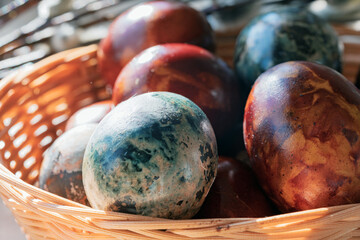 Basket with naturally dyed Easter eggs and pussy willow branches