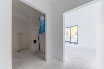Unfinished apartment interior with hallway and room view