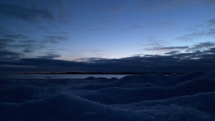 Calm frozen sea at winter sunrise