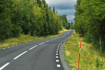 Winding road through Sweden Lapland forest landscape