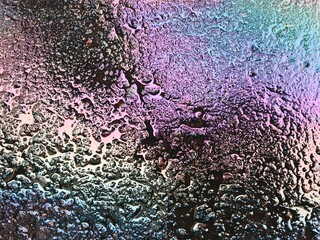 Abstract Iridescent Oil Spill Patterns on Wet Asphalt. Vibrant rainbow-like iridescent patterns...