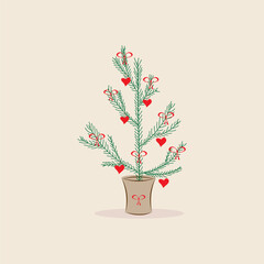 A Christmas tree with red hearts and bows is standing in a pot. The concept of Christmas, New Year, and Valentine's Day.