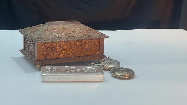 Vintage treasure box and person moving silver bars in 4k video