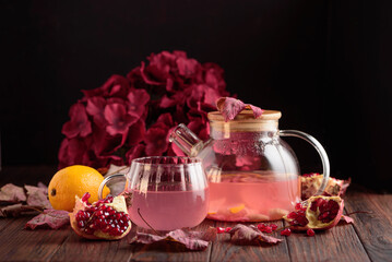 Autumn Beverage: Pomegranate Tea with Lemon and Ginger on Rustic Table