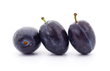 Three ripe purple plums isolated on a white background.