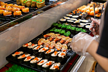 Colorful sushi platter featuring variety of sushi types, including rolls and garnishes, arranged neatly on serving tray, showcasing vibrant colors and textures of ingredients