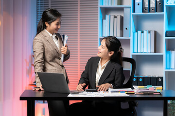 Business Conversation in the Office: Two professional individuals engage in an engaging conversation, exchanging ideas, and working together towards a common purpose within a modern office setting.