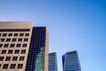Fototapeta premium Futuristic facades of corporate buildings against a blue sky background, Tel Aviv, Israel.