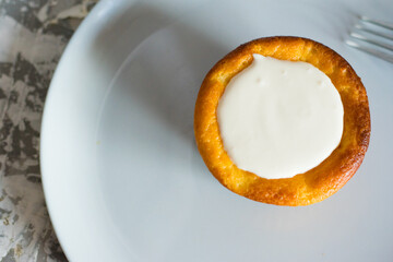 Delicious cheesecake with sour cream on a plate. Breakfast concept for the family