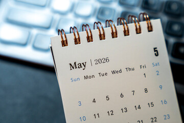 A calendar page displays May 2026 with dates organized week-by-week. This image offers a clear view suitable for time management themes, office settings, or planning activities.