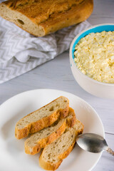 Whole grain baguette made from buckwheat flour and sesame seeds, and salad with egg