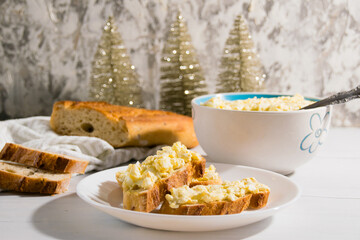 The process of preparing for the Christmas and New Year holidays. Making sandwiches with baguette, processed cheese and egg