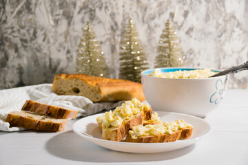 The process of preparing for the Christmas and New Year holidays. Making sandwiches with baguette, processed cheese and egg