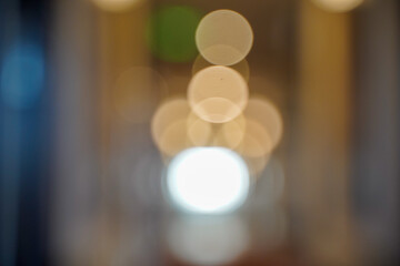 Soft abstract background of large, warm, circular bokeh lights out-of-focus highlights in a vertical composition