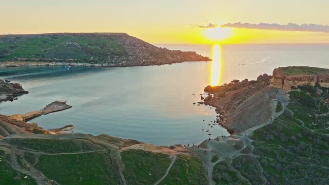 Drone view of famous sunset point on Ghain Tuffieha beach, rocks. Mediterranean sea, Malta island