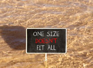 Naklejka premium One size does not fit all symbol. Concept words One size does not fit all on beautiful blackboard. Beautiful Red sea water background. Business one size does not fit all concept. Copy space.
