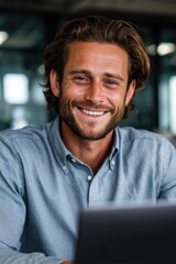 Fototapeta premium Smiling businessman with laptop