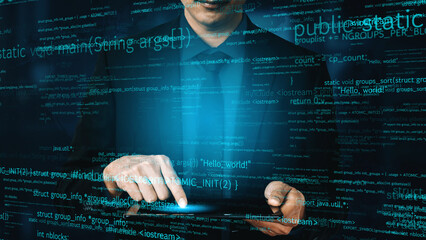 A businessman in a suit interacts with a futuristic digital coding interface while programming on a tablet, surrounded by glowing text and data elements. Xenic