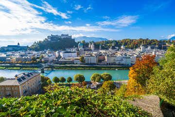 Fototapeta premium City of Salzburg with Salzach River and Fortress Hochensalzburg in the fall season.