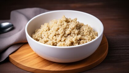 Cooked quinoa in white bowl, healthy food.