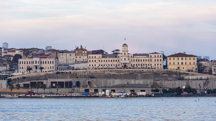 Fototapeta premium Night view of Istanbul featuring glowing historic waterfront landmarks along the Bosphorus, city lights reflecting on dark water, and a dramatic skyline atmosphere in Turkey.