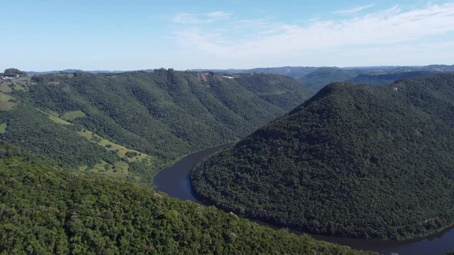 Drone footage of Gelain viewpoint showing the horseshoe bend of Rio das Antas on a bright sunny day, scenic natural landscape in Flores da Cunha, Serra Gaucha, Brazil