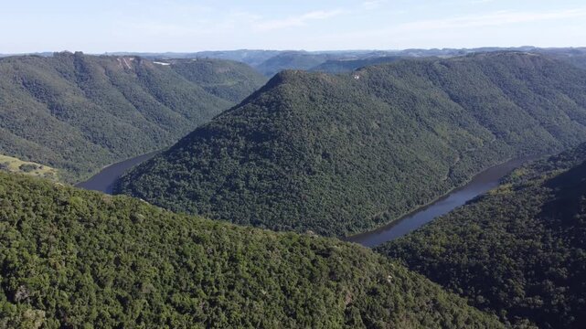 Drone footage of Gelain viewpoint showing the horseshoe bend of Rio das Antas on a bright sunny day, scenic natural landscape in Flores da Cunha, Serra Gaucha, Brazil