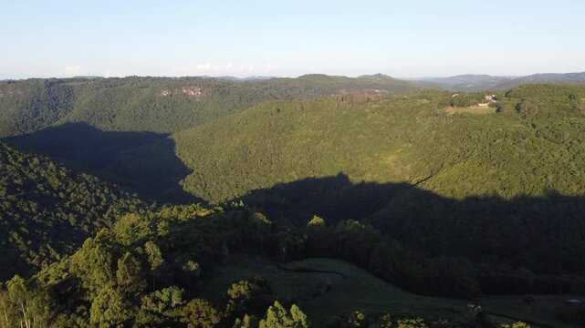 Drone footage of rural Flores da Cunha landscape with valleys, araucaria trees and lush nature during autumn, scenic countryside view in Serra Gaucha, Brazil