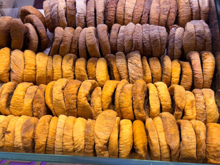 Dried fig slices stacked in orderly rows forming a dense textured surface. Traditional fruit preservation, natural sweetness, and nutrient rich snacking represented through repetition and organic