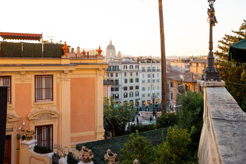 Festive panoramic view of Rome near the Spanish Steps with warm winter light, historic architecture and lively city below. Holiday tourism, city break travel, celebration, inspiration and European