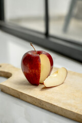 Fresh red apples have been sliced ​​on a wooden cutting board. Red apples. Food photography concept.