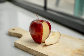 Fresh red apples have been sliced ​​on a wooden cutting board. Red apples. Food photography concept.