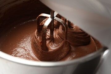Fototapeta premium Mixing chocolate dough in bowl, closeup view