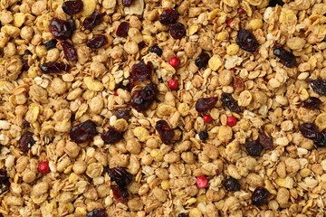 Tasty granola with dried fruits as background, top view