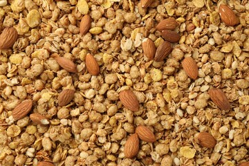 Tasty granola with nuts as background, top view