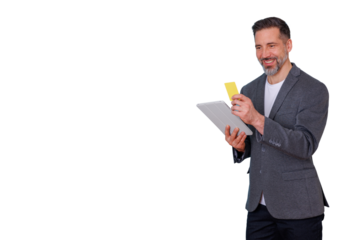 Man smiling while holding credit card and tablet, shopping online, making e-commerce payment transaction