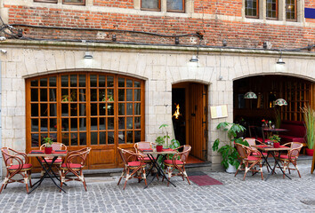 Old street with tables of cafe in center of Brussels, Belgium. Cozy cityscape of Brussels (Bruxelles). Architecture and landmarks of Brussels.