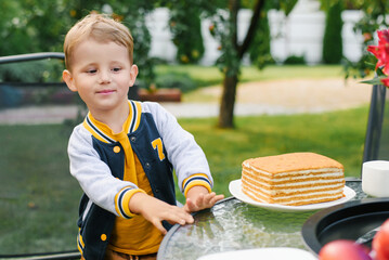 Little Boy Smiling Near Cake On Table
