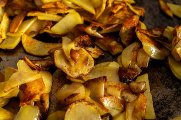 Potatoes are fried in a pan. Delicious, golden slices of potatoes are cooked in butter. The process of cooking the dish
