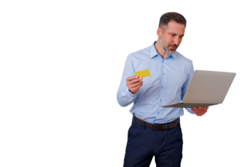 Man holding credit card and laptop, looking confused while attempting online shopping or making a digital payment