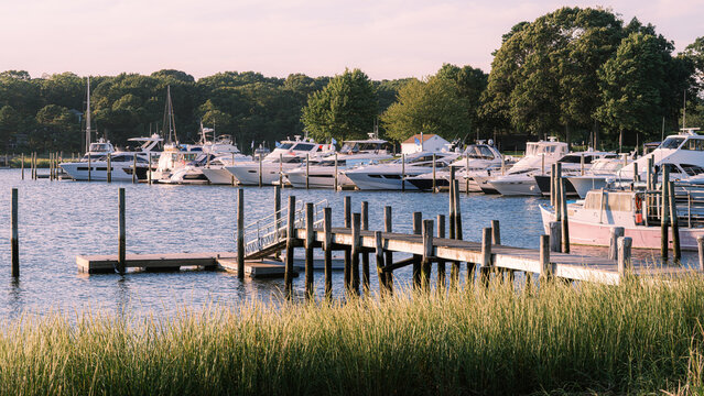 Recreational boats docked at a marina along the Long Island shoreline