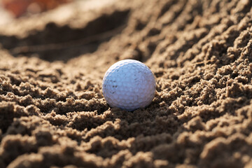 Used golf ball that finds itself in a difficult situation after the shot that every golfer knows