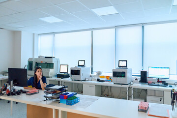 Scientist working in a modern laboratory setting with advanced equipment during the day
