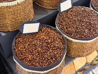 Roasted coffee beans stored in woven baskets with open display and natural textures in Istanbul bazaar. Craft roasting, market authenticity, aroma expectation, and traditional retail culture through