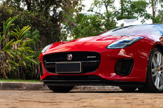 Red Jaguar F-Type front grille close up, low angle view of luxury sportscar