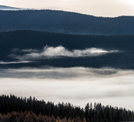 Layers of Fog over Mountain Forest. Layered mountain forest covered in drifting fog and soft light, creating a calm, atmospheric landscape ideal for nature, environment and background concepts.