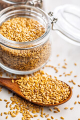 Golden linseed or flaxseed. Healthy flax seed on wooden spoon on kitchen table.