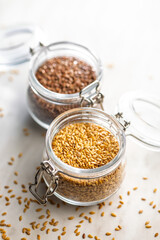 Golden linseed or flaxseed. Healthy flax seed in jar on kitchen table.
