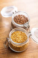 Golden linseed or flaxseed. Healthy flax seed in jar on wooden table.
