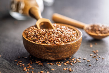 Linseed or flaxseed. Healthy flax seed in bowl on black table.